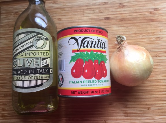 Olive oil, tomatoes and an onion